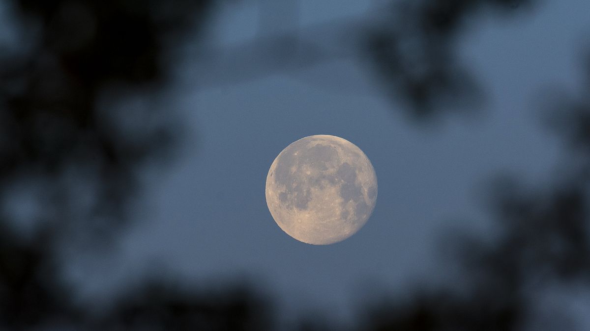 The full moon is seen prior to sunrise above Debrecen, Hungary, Wednesday, April 28, 2021.