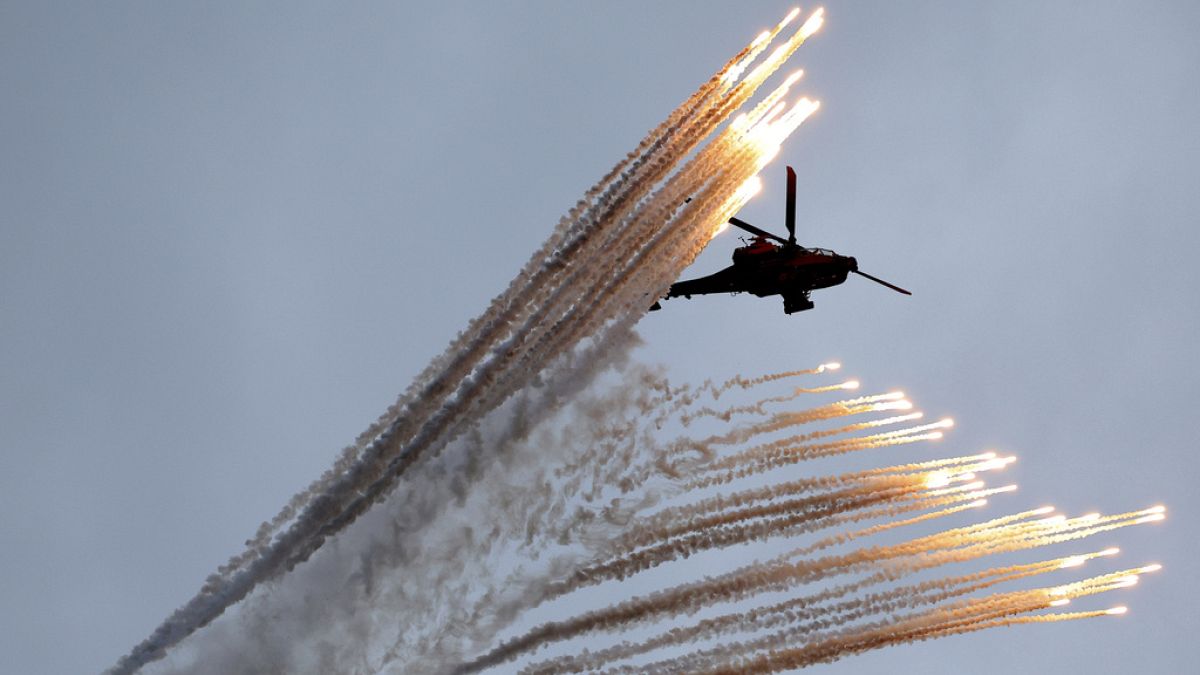 A South Korean army Apache helicopter fires flares during a celebration to mark 76th anniversary of Korea Armed Forces Day, in Seongnam, South Korea, Tuesday, Oct.1, 2024