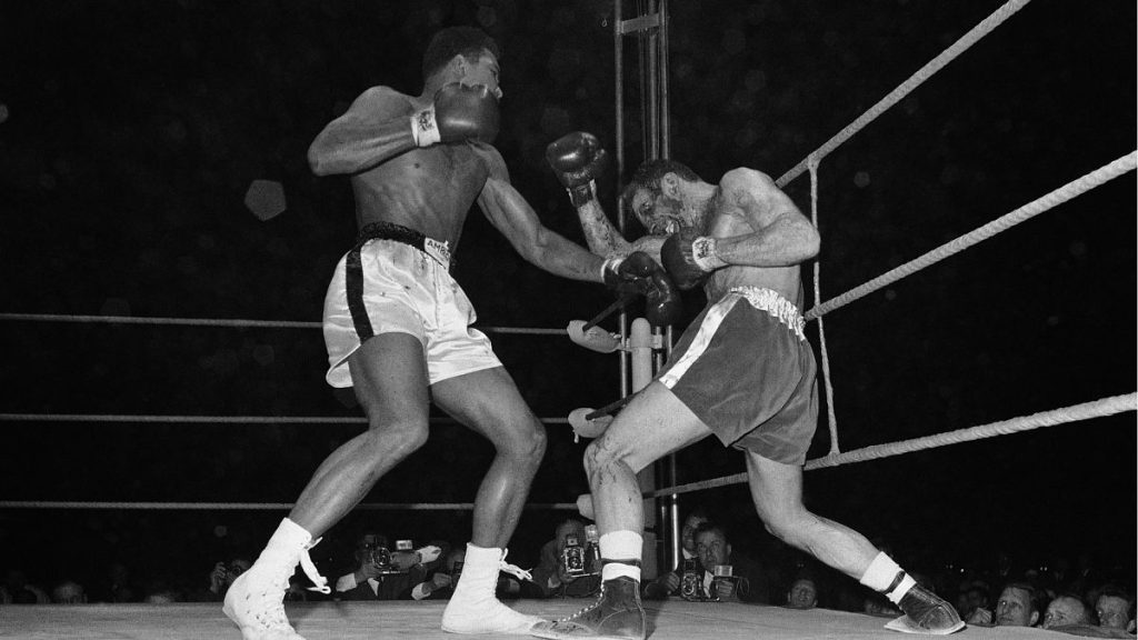 Muhammad Ali, left, throws a left to the badly gashed left eye of British Challenger Henry Cooper during their 1966 rematch