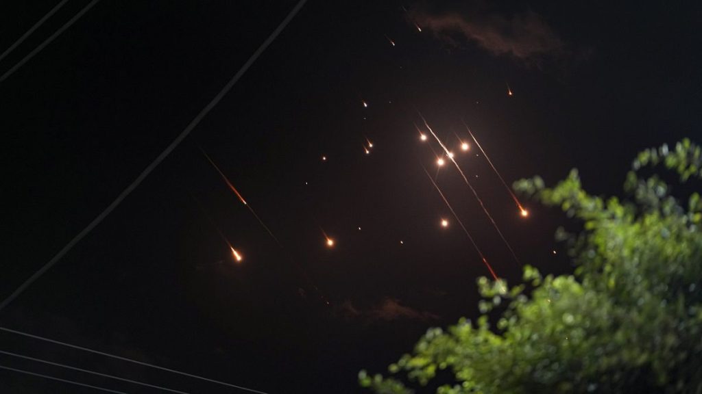 Missiles launched from Iran towards Israel streak across the night sky as seen from Deir al-Balah, Gaza Strip, Tuesday, Oct. 1, 2024.