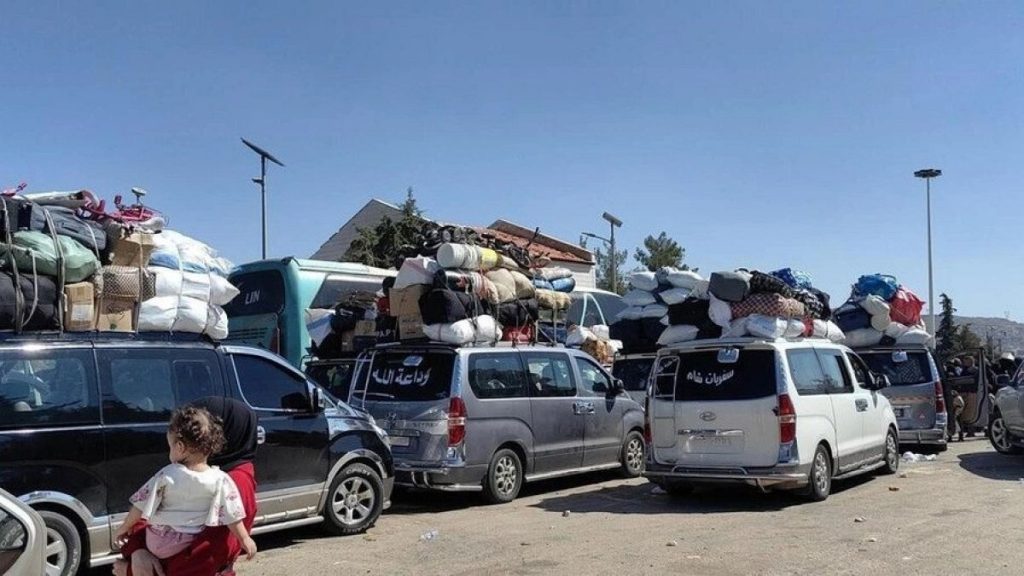 Families fleeing Israeli airstrikes in Lebanon arrive at the Syrian border on Tuesday.