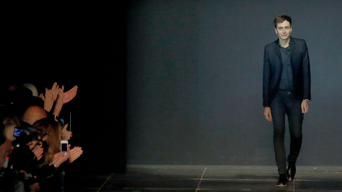 French-born fashion designer Hedi Slimane for St Laurent appears at the end of his ready to wear Spring-Summer 2013 collection presented in Paris, Monday, Oct.1, 2012