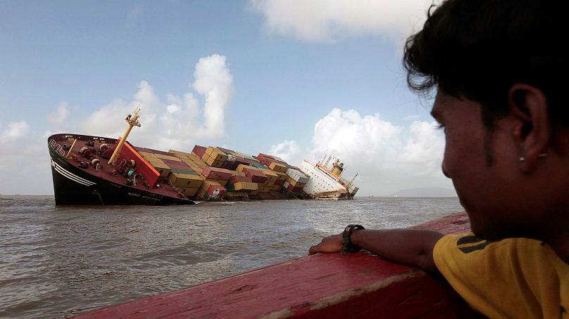 A man looks at the container ship MSC Chitra that days earlier collided with the MV-Khalijia-II in the Arabian Sea near Mumbai, India, August 2010.