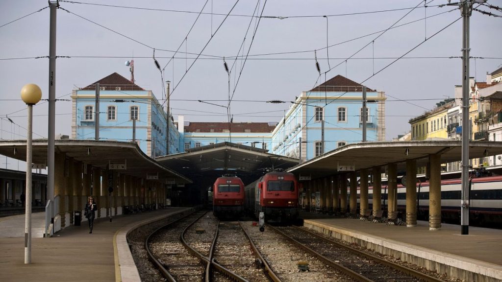 A woman walks in the Santa Apolonia train station in Lisbon.