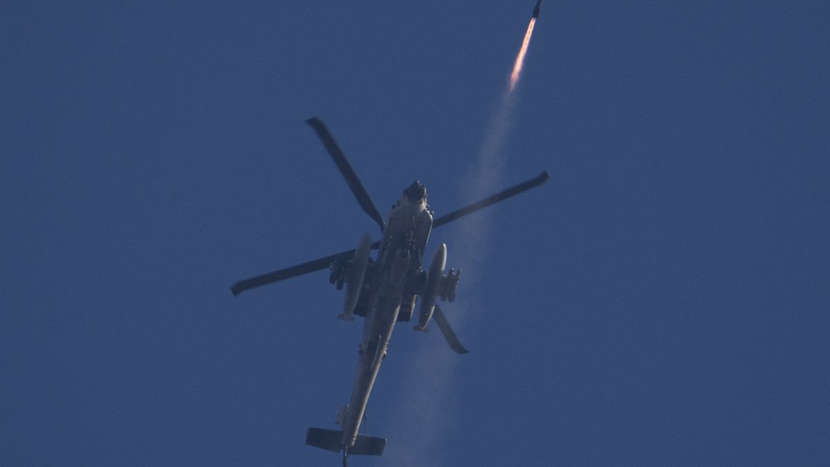 An Israeli Apache helicopter fires a missile towards southern Lebanon as seen from northern Israel, October 4, 2024