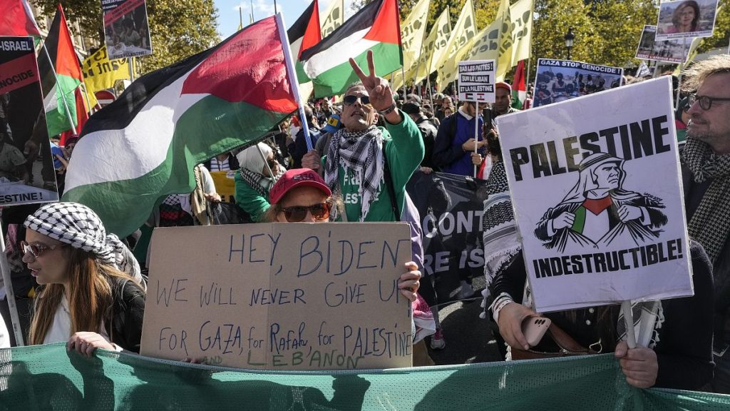 Protesters march with banners and flags during a rally in support of Palestine and Lebanon in Paris, October 5, 2024