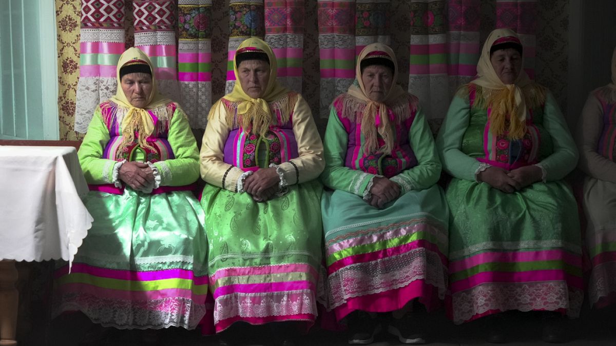 FILE - Women in traditional Doukhobor dresses pray at Easter in the remote mountain village of Gorelovka, Georgia, Saturday, May 4, 2024