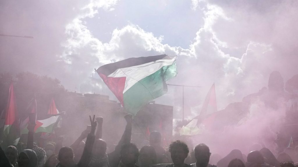 People attend at a protest in Rome, Saturday, Oct. 5, 2024. Pro-palestinians people take to the street in an unauthorised march in the centre of Rome two days ahead of the fir