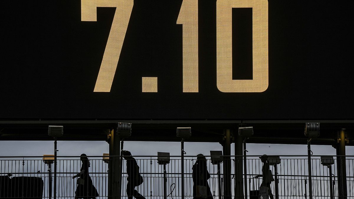 People cross a bridge with the date 7.10, marking the Hamas attack on Israel, on the eve of the one-year anniversary, in Ramat Gan, October 6, 2024