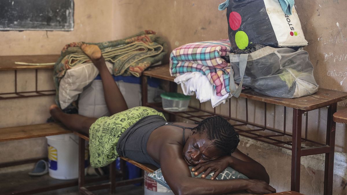 A person affected by gang violence takes refuge at the Antoinette Dessalines National School, which has been converted into a temporary shelter.