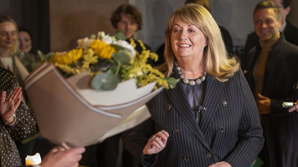 Leader of the Social Democratic Party Vilija Blinkevičiūtė congratulates colleagues as she waits for the results of the first round of the election, 13 October, 2024