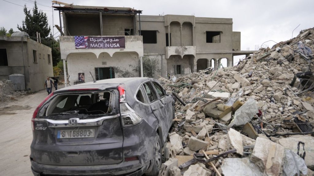 A car sits on the rubble of a building damaged in an Israeli airstrike, in Maisara near the northern coastal town of Byblos, Lebanon.