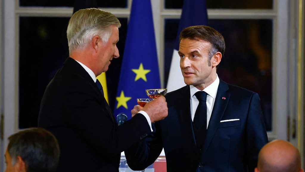 French President Emmanuel Macron, right, holds a glass for a toast with Belgium