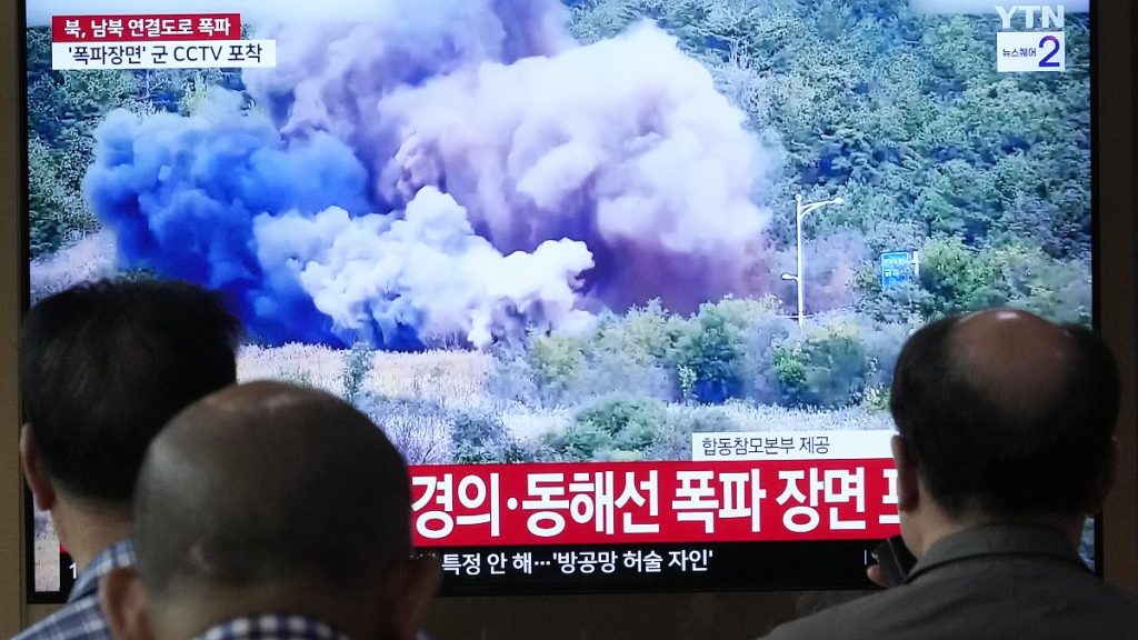 A TV screen reports North Korea has blown up parts of northern side of inter-Korean roads during a news program at Seoul Railway Station in Seoul, Tuesday, Oct. 15