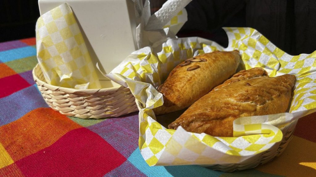 A basket of Mexican pastes sit on a patron