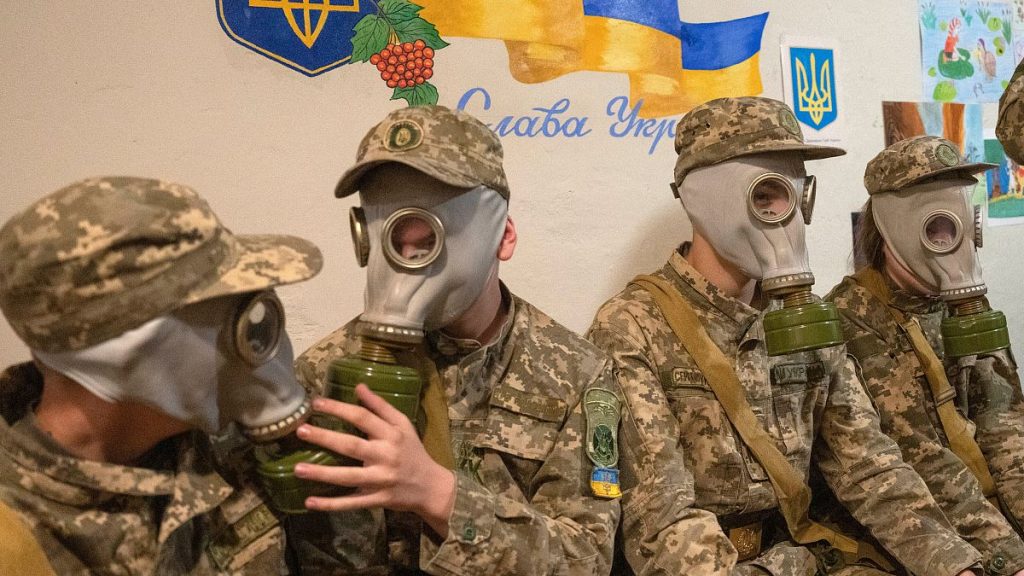 Ukrainian cadets practice trying on gas masks during a lesson in a bomb shelter in Kyiv.