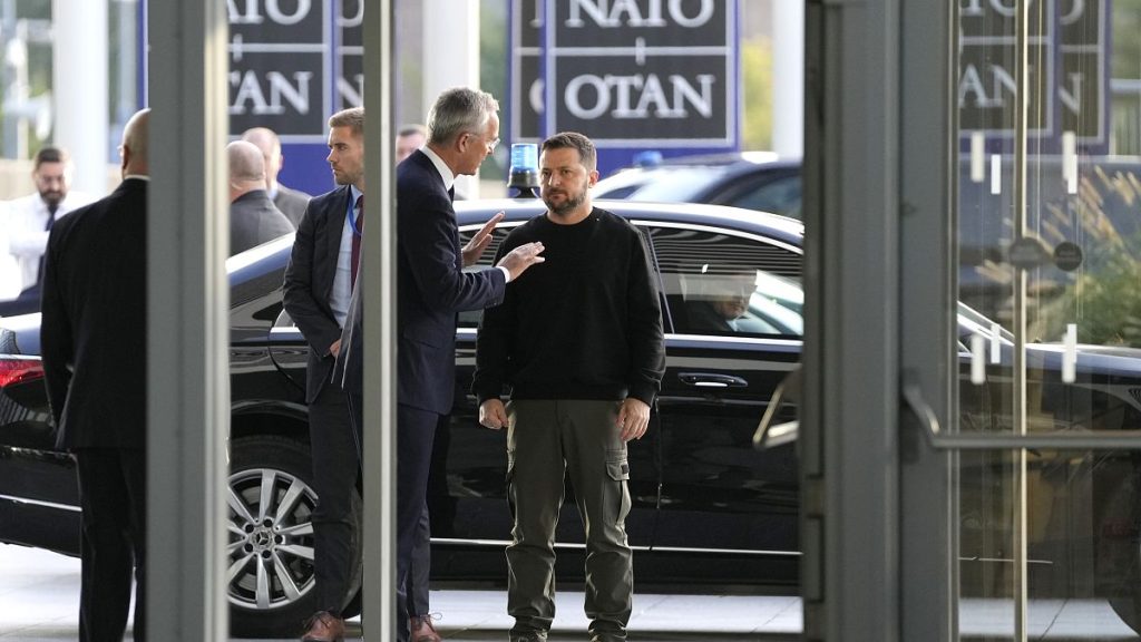 Former NATO Secretary General Jens Stoltenberg, center left, speaks with Ukraine