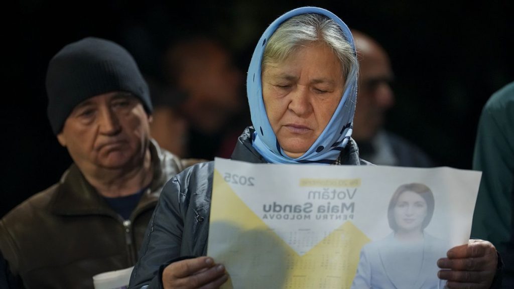 A woman looks at a paper promoting Moldova