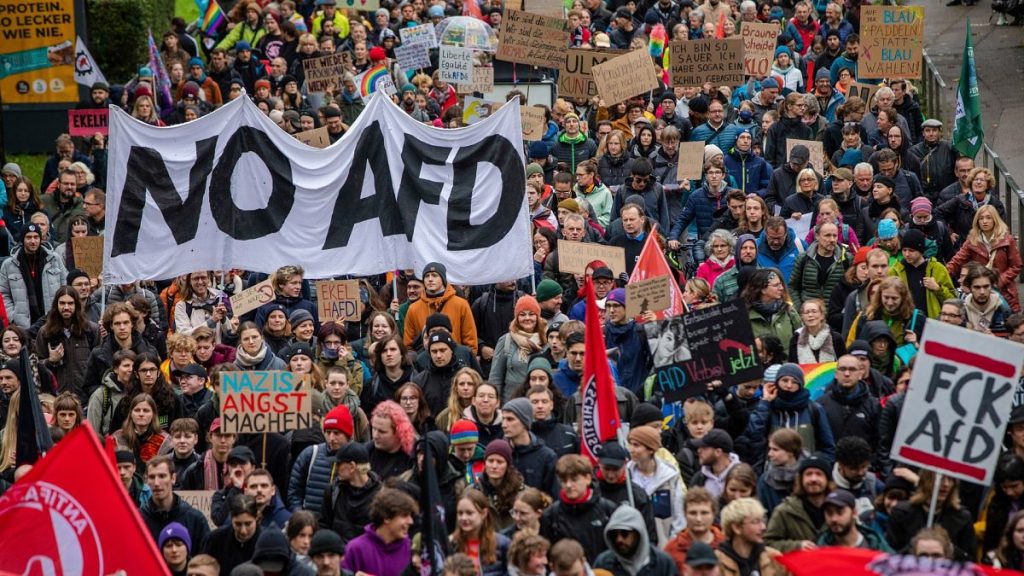 People march during a demonstration against the AfD right wing party, in Ulm, Germany, Saturday, Oct. 5, 2024.