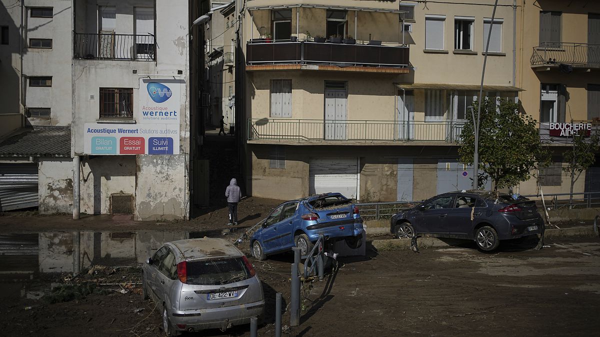 A man walks in a flooded street in Rive-de-Gier after torrential rains and flooding submerged roads and railways, 18 October, 2024