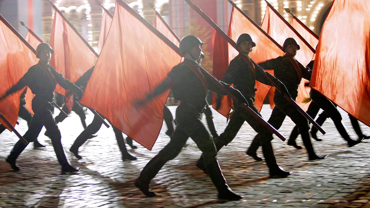 FILE: Russian soldiers with Soviet Army Red flags march during a rehearsal for the Victory Day military parade at the Moscow Red Square, 4 May 2010