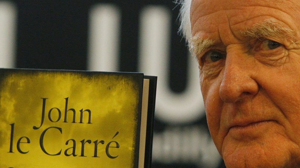 John le Carre holds a copy of his new book entitled