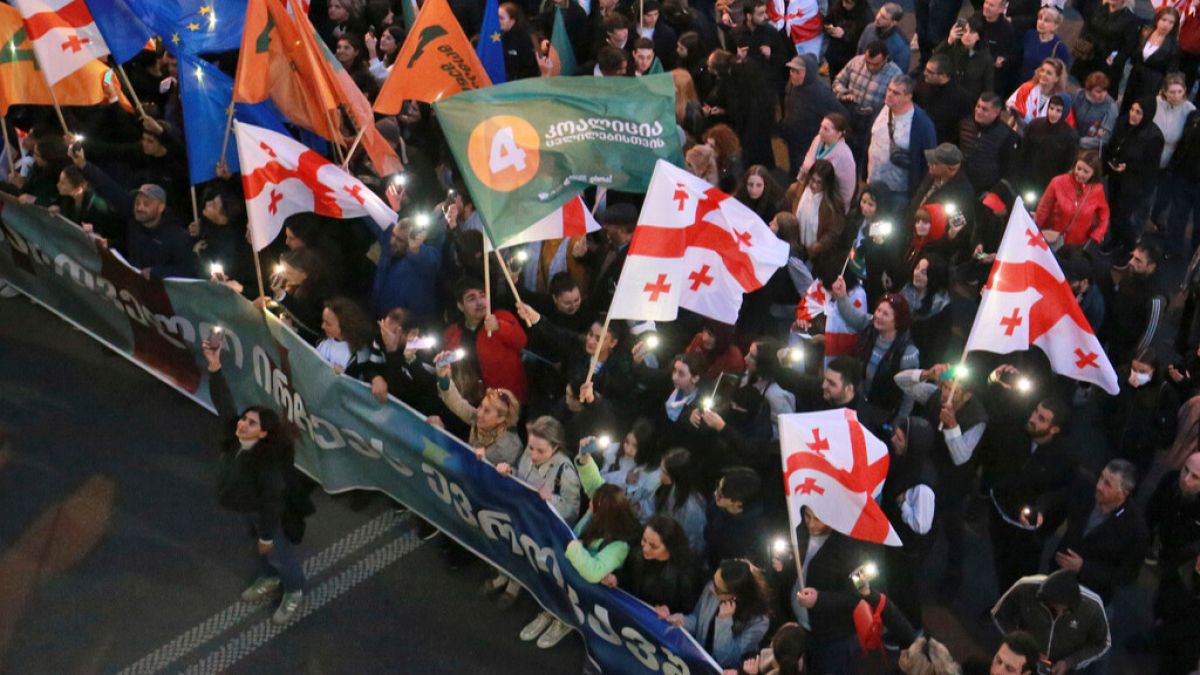 Demonstrators march during an opposition rally ahead upcoming next week parliamentary election in Tbilisi, Georgia, Sunday, Oct. 20, 2024.