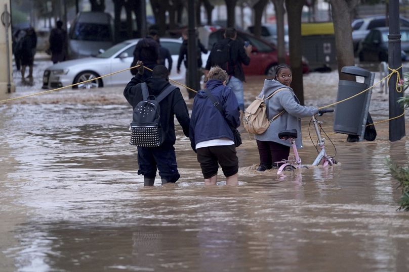 Des gens marchent dans les rues inondées de Valence