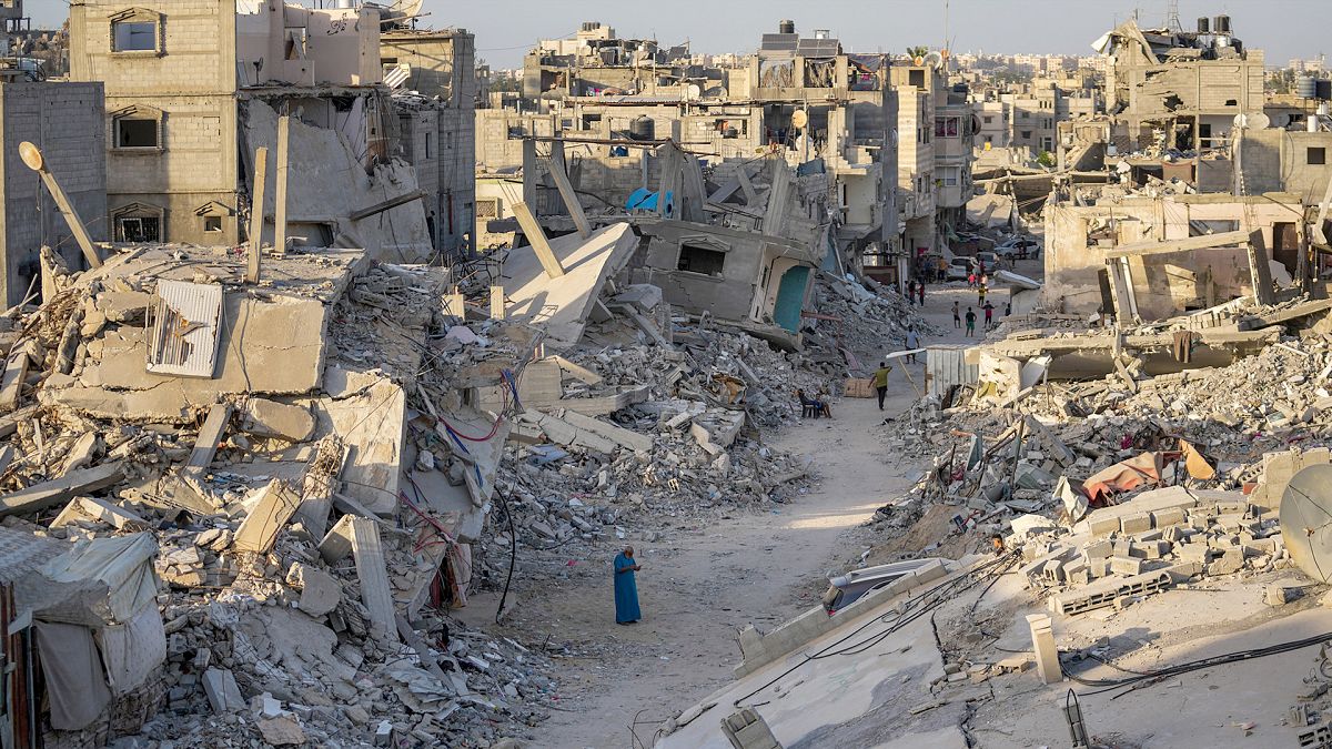 FILE: Palestinians walk through the destruction left by the Israeli air and ground offensive on Khan Younis, Gaza Strip, 12 September 2024