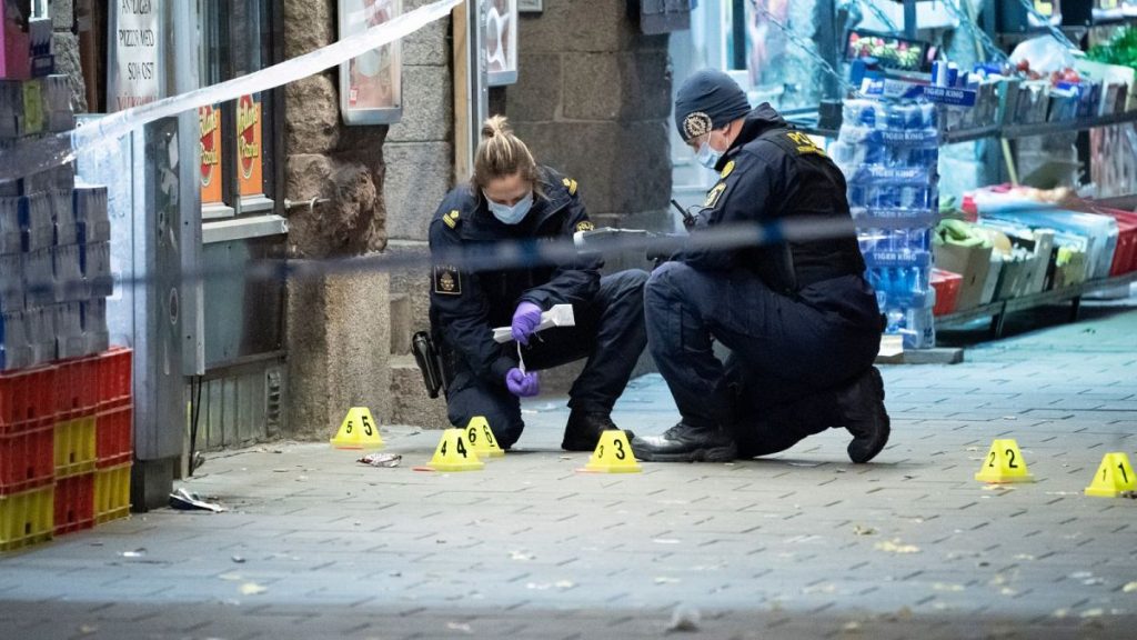 Police officers work near the scene of a shooting, in Malmo, Sweden.