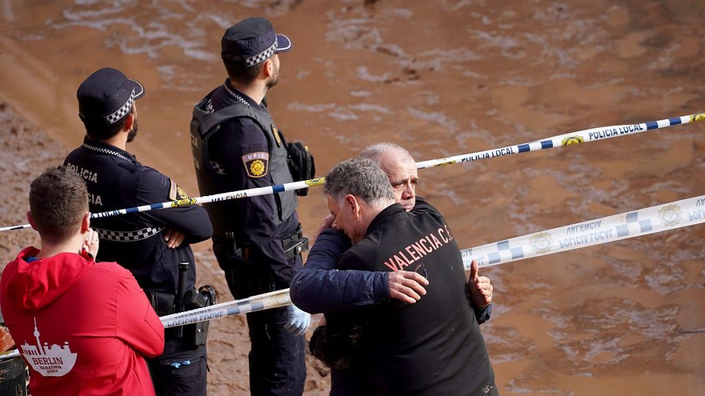 Residents react as they wait for news of their relatives trapped during the floods in Valencia, Spain, Thursday, Oct. 31, 2024.