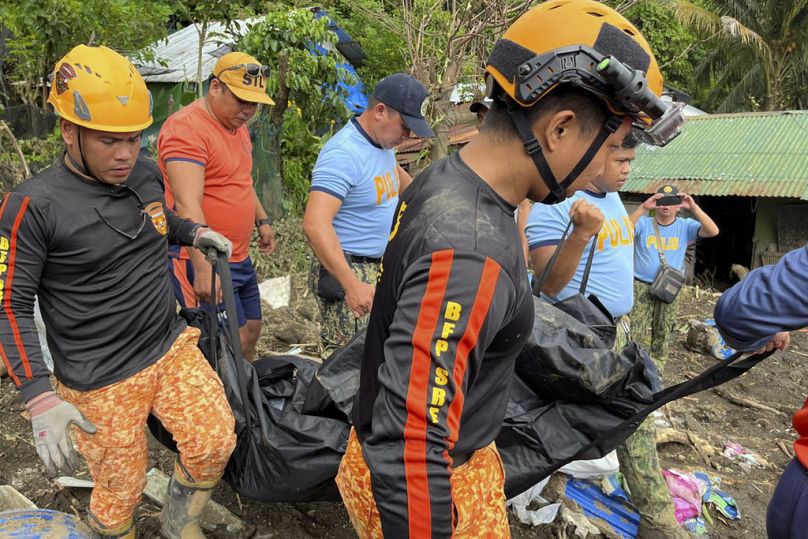 Les sauveteurs transportent un corps lors des opérations de récupération après un glissement de terrain déclenché par la tempête tropicale Trami, qui a frappé des maisons à Talisay, province de Batangas, Philippines, le 26 octobre 2024.