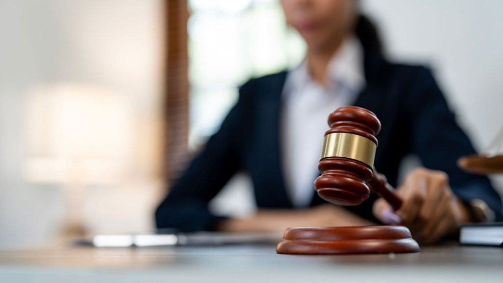 A judge with a mallet in a court