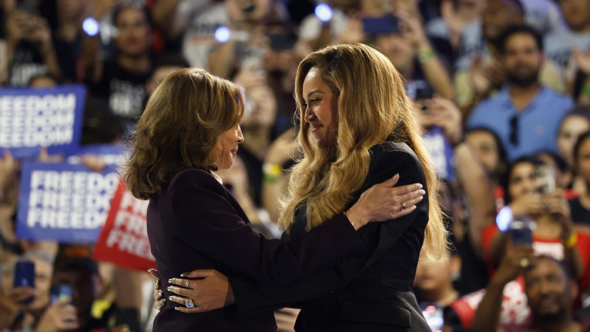 Musical artist Beyonce, right, and Democratic presidential nominee Vice President Kamala Harris, left, embrace on stage during a campaign rally Friday, Oct. 25, 2024,