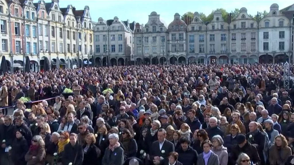 Attendees of a tribute ceremony for Domonique Bernard one-year on from his murder in the northern French town of Arras, on 13 October, 2024.