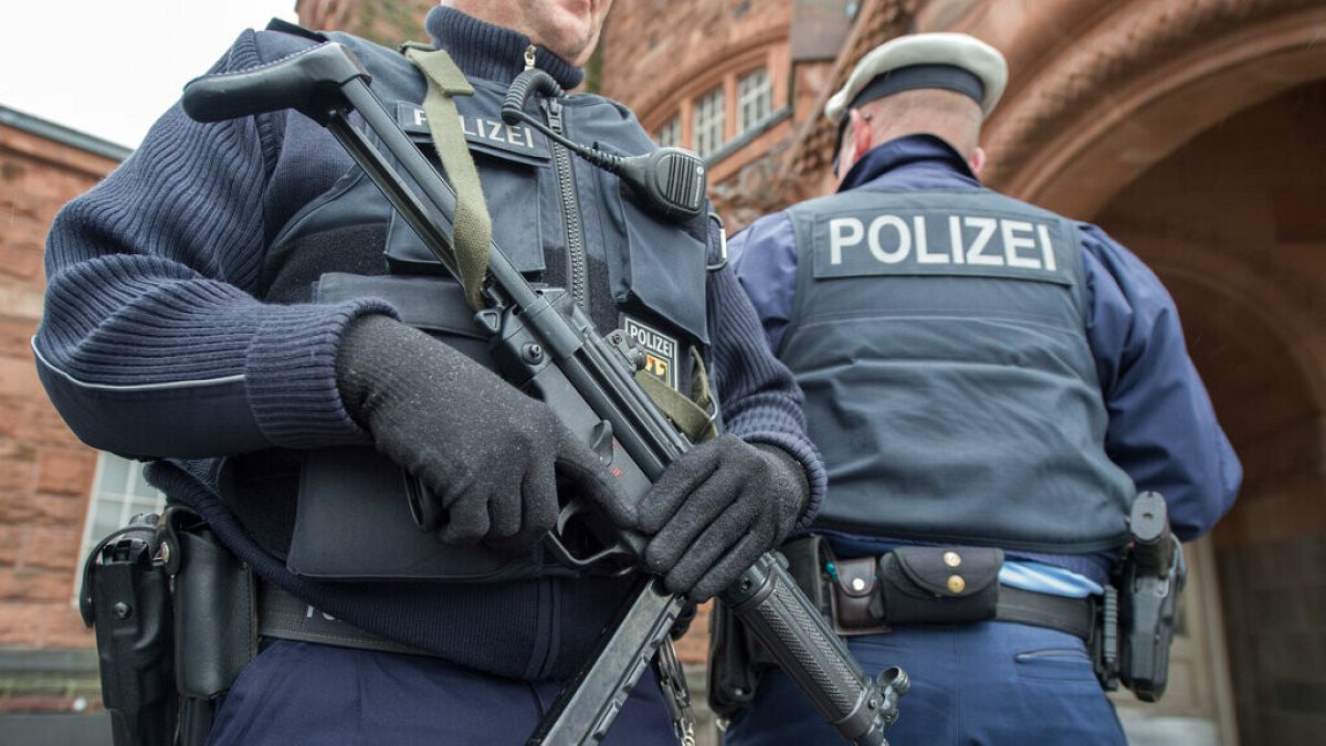 File photo: Police officers stand outside a train station in central Germany