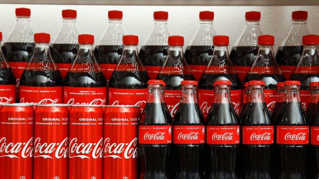 Coca-Cola cans and bottles on display in a store