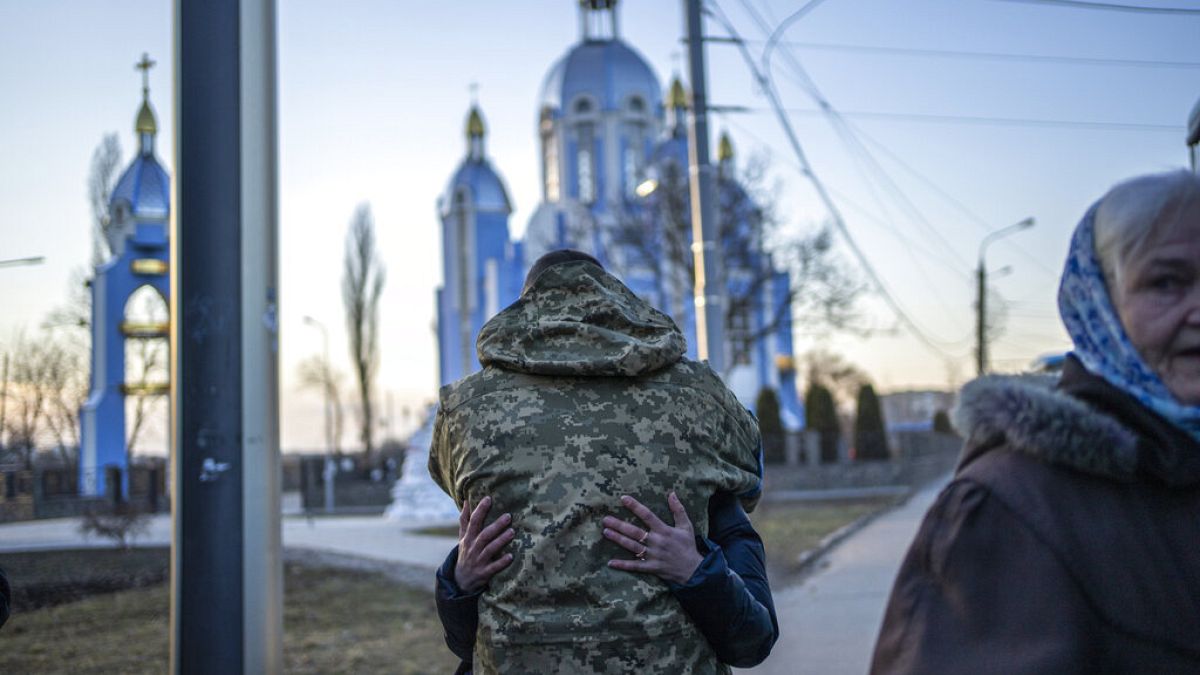 A soldier embraces a relative fleeing the war in Vinnytsia, Ukraine, in 2022.