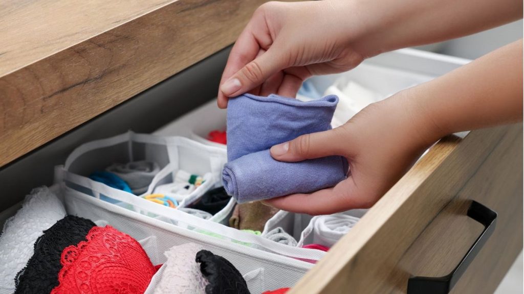 A woman opens the underwear drawer.