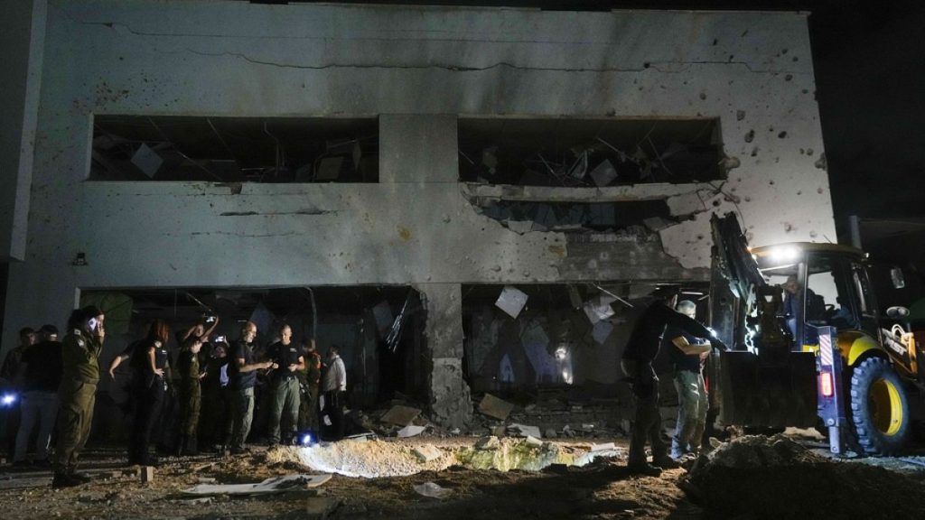 Israeli military and police work at a damaged school building that was hit by missiles fired from Iran in Gadera, Israel