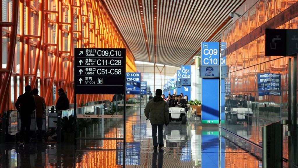 Workers walk through the new Terminal 3 building at Beijing Airport Tuesday Feb. 26, 2008.