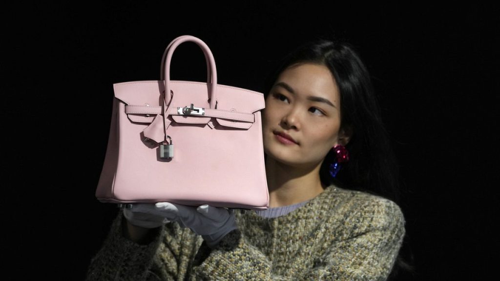 A Bonhams employee displays a Hermes: Rose Sakura Swift Leather Birkin 25 bag at the auction rooms in London. 26 February 2024.