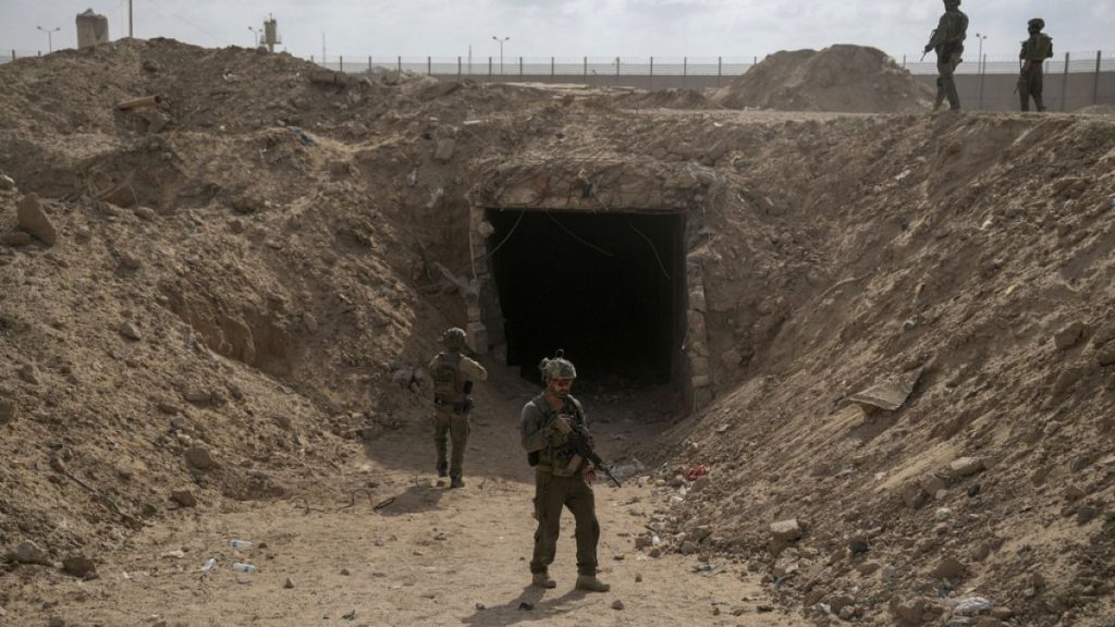 Israeli soldiers standing in front of a tunnel