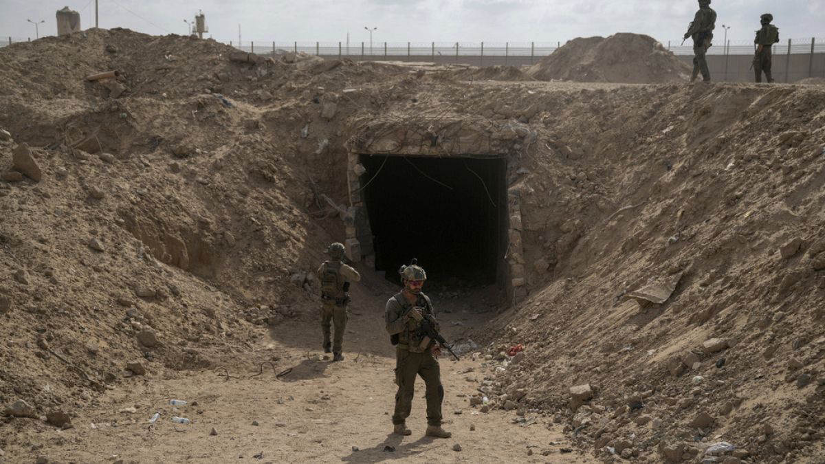 Israeli soldiers standing in front of a tunnel