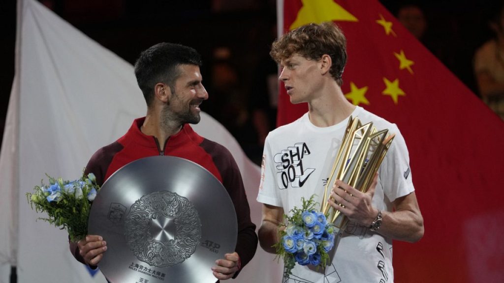 Jannik Sinner right, chats with Novak Djokovic.