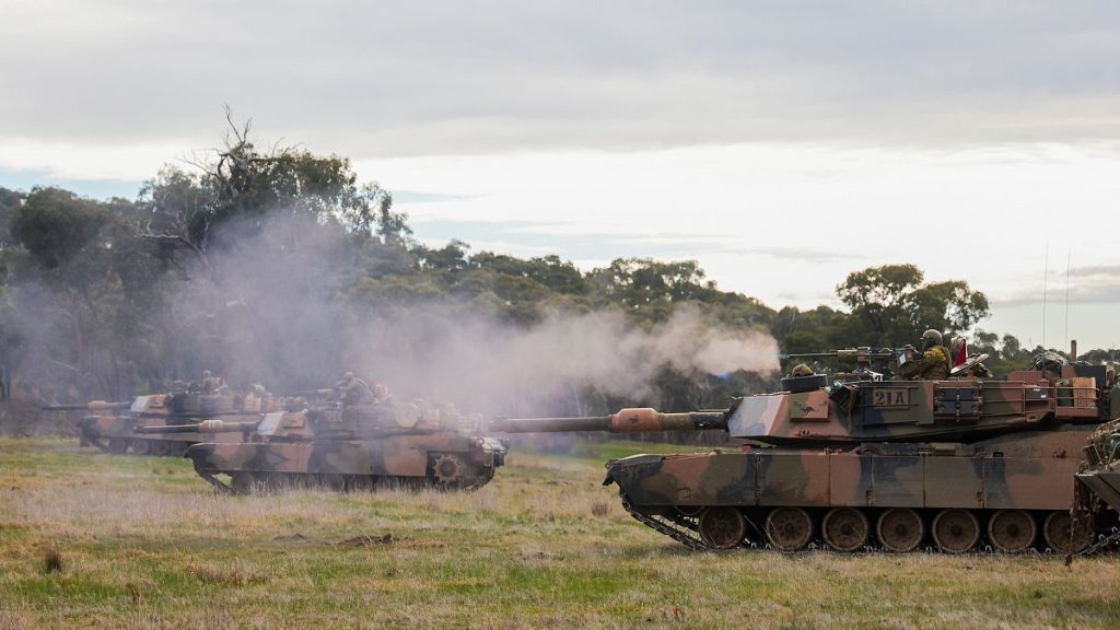 An Australian Army trooper fires from an Australian Army M1A1 Abrams Main Battle Tank during an exercise at the Puckapunyal Military Area in Victoria, Australia.