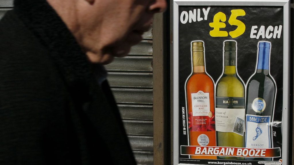 A pedestrian passes by a UK shop selling cheap alcohol products in 2012, before Scotland