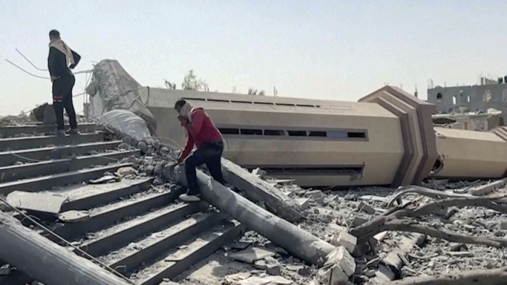 People observe a mosque destroyed by Israeli airstrikes in the city of Khan Younis, sothern Gaza Strip, Friday, Oct. 25, 2024.