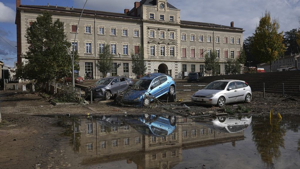 Cars are seen washed up in Rive-de-Gier, central France, after torrential rains and flooding submerged roads and railways.