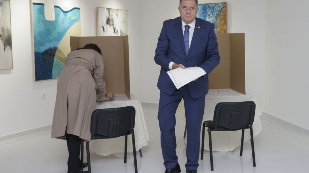 Bosnian Serb leader Milorad Dodik, right, prepares his ballot for the local elections at a polling station in Laktasi, northwest of Sarajevo, Bosnia, Sunday, Oct. 6, 2024.